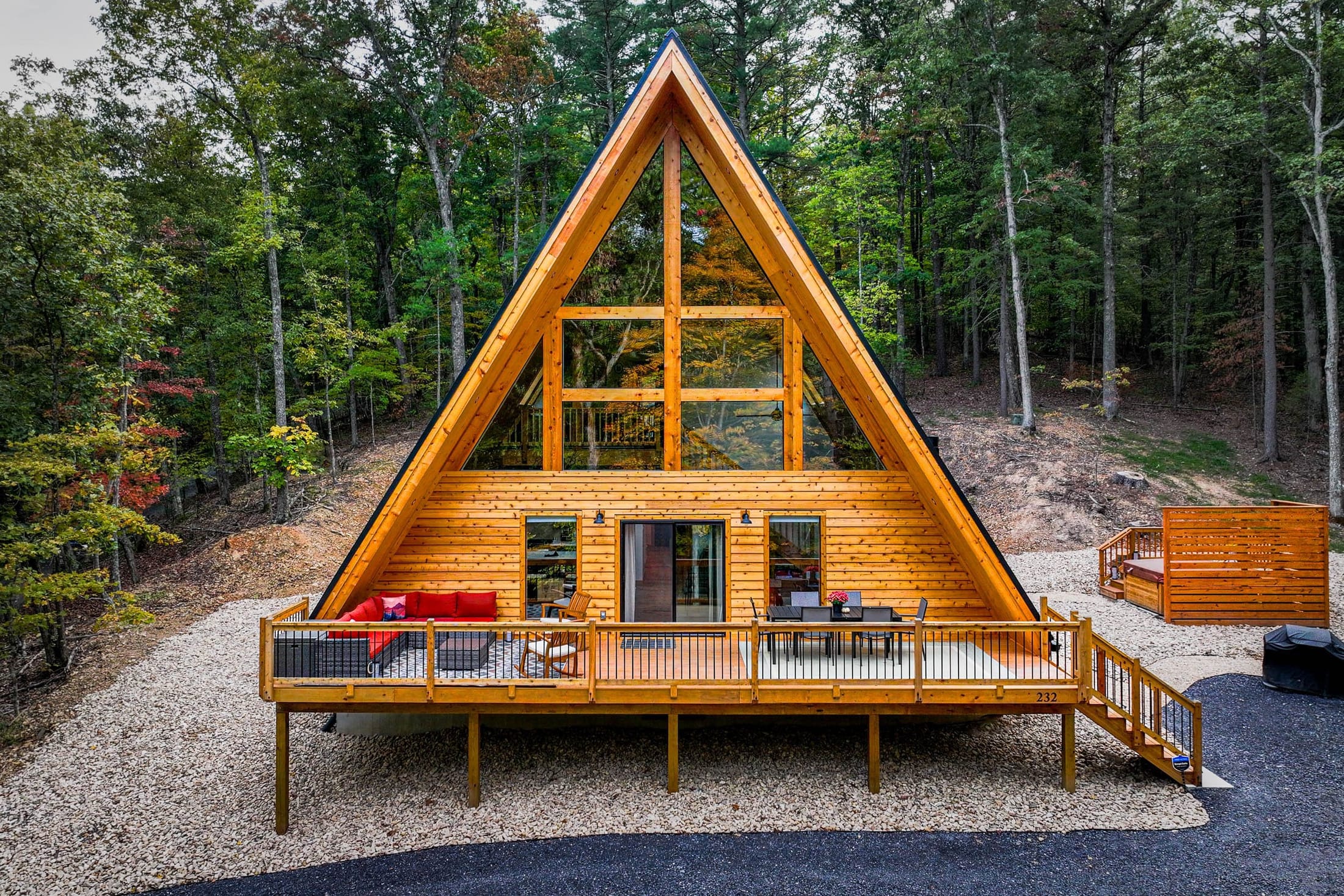 Front exterior of The Shack A-frame cabin surrounded by forest